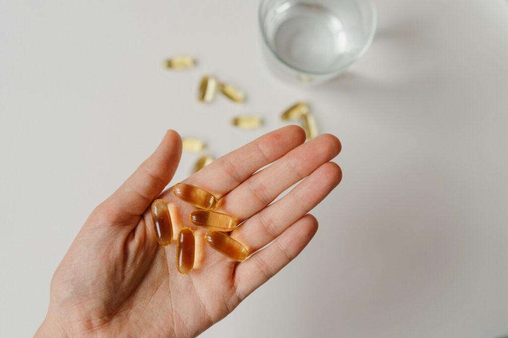 pills on the palm, health care, vitamins and supplements