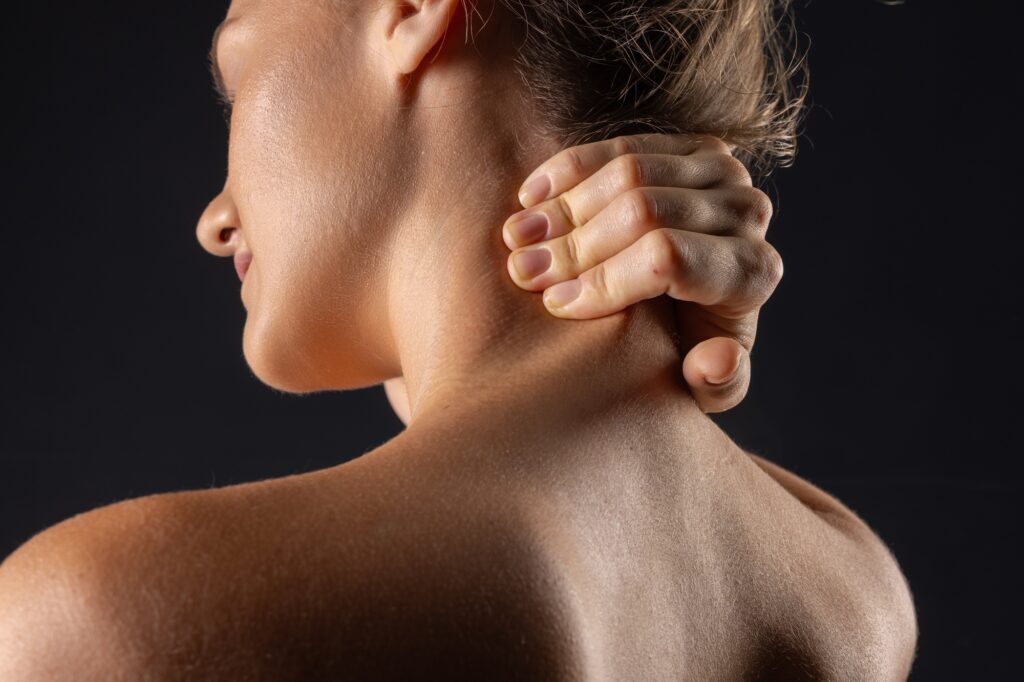 woman massaging neck close up, concept of neck pain with osteochondrosis protrusion and hernia